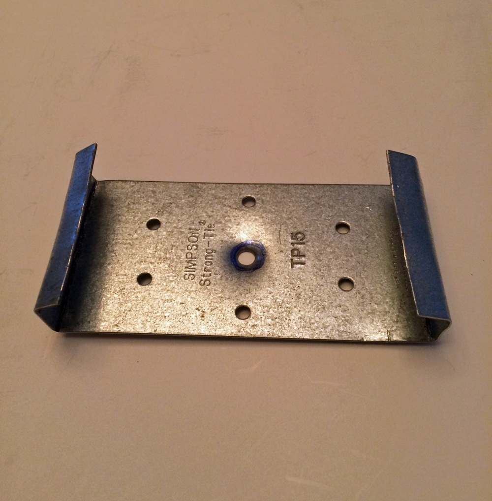 Tie plate with dimple in center