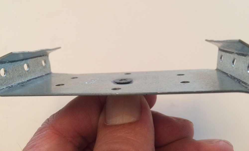 Tie plate with countersunk screw