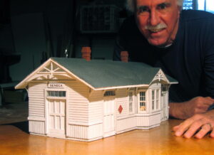 man with model of depot