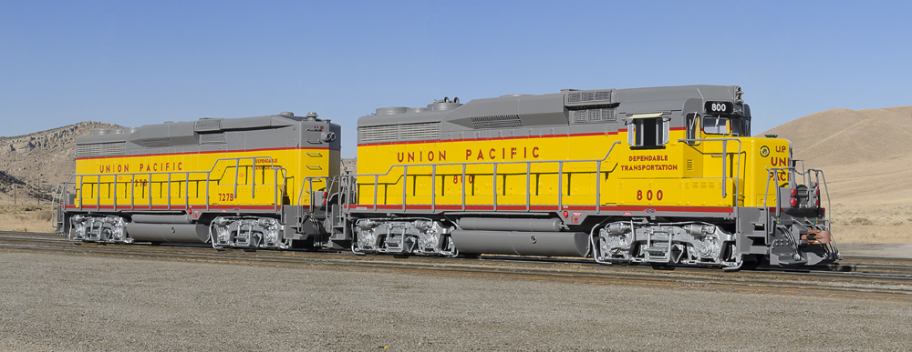 Yellow and gray painted locomotives (A and B units coupled).
