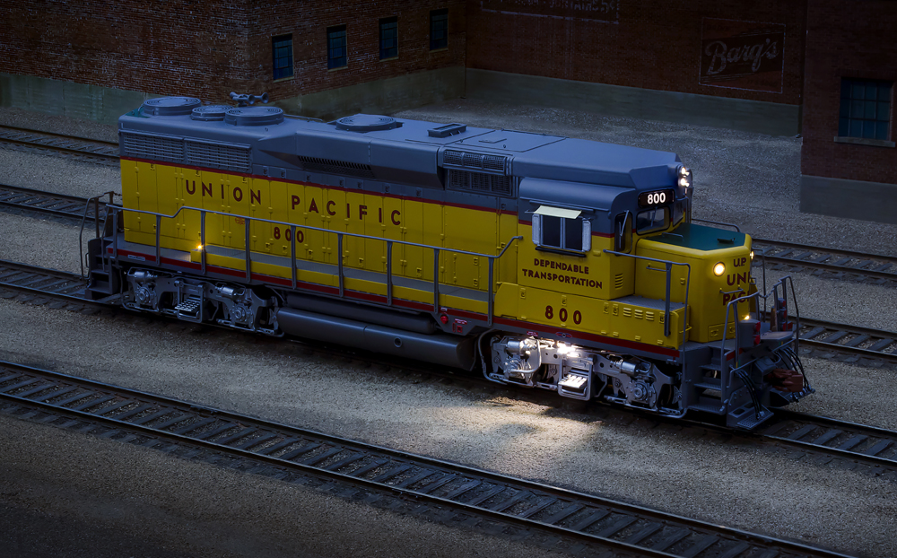 Night image of a yellow locomotive with additional lights.