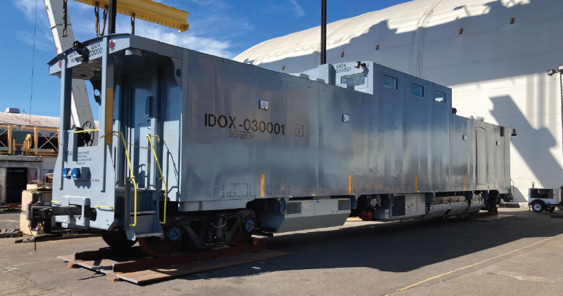 light blue boxy railcar