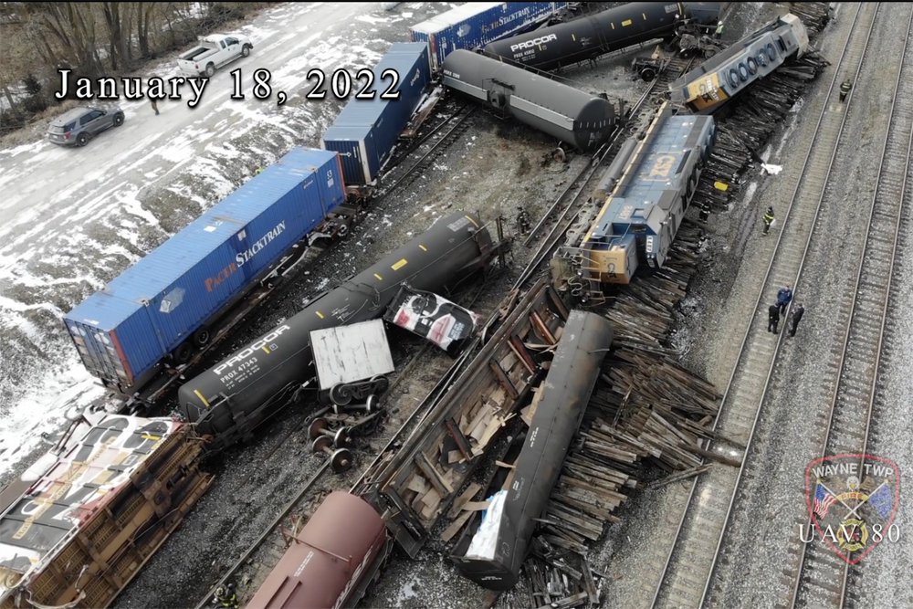 Overturned locomotives and freight cars in railyard