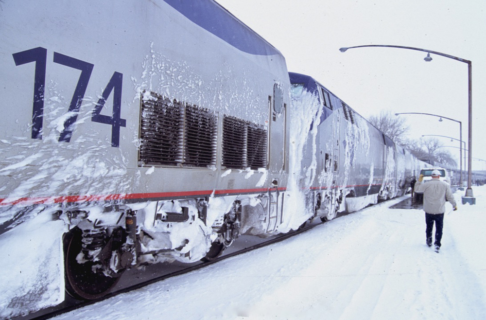 Locomotives on passenger train caked with snow on