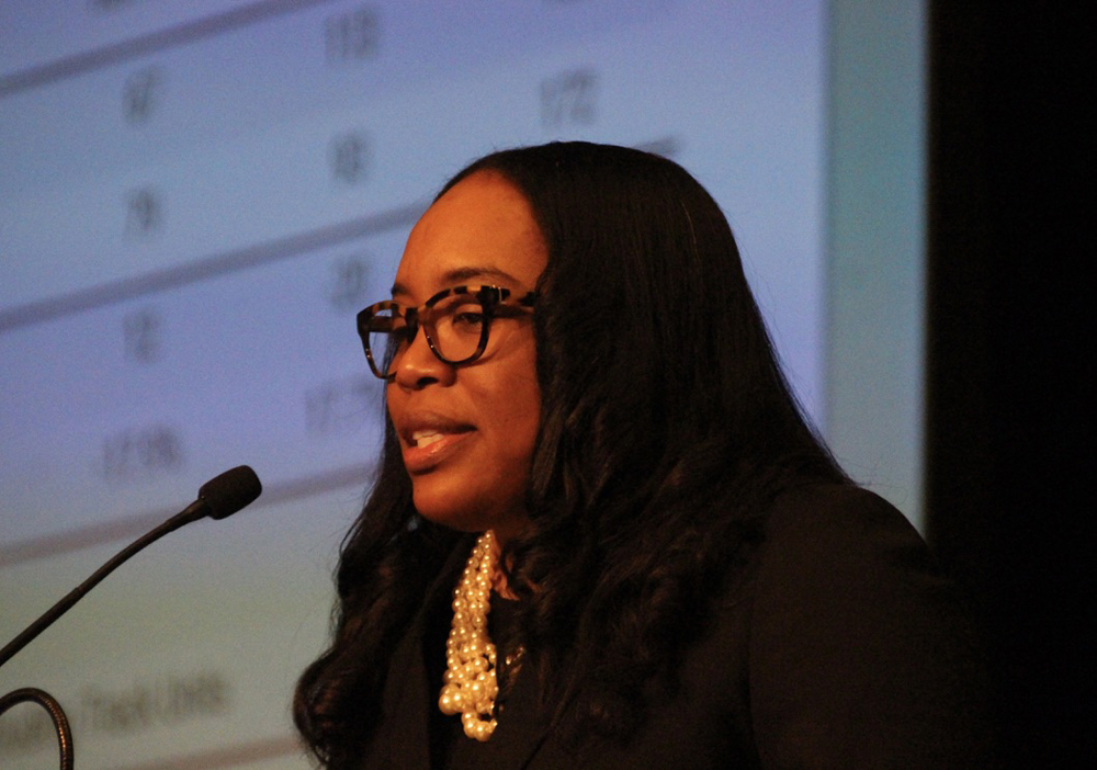 Woman with glasses at microphone