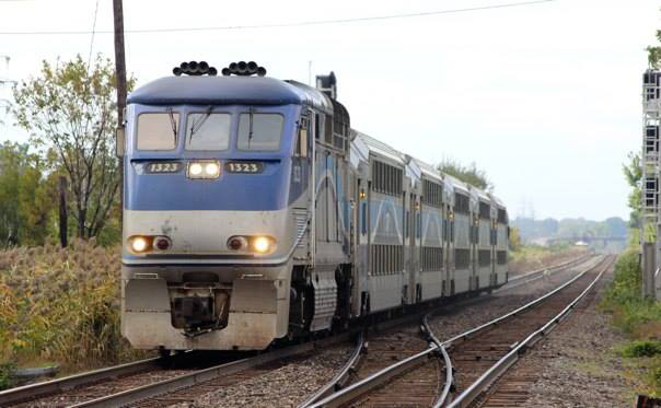 Blue and silver locomotive with commuter train