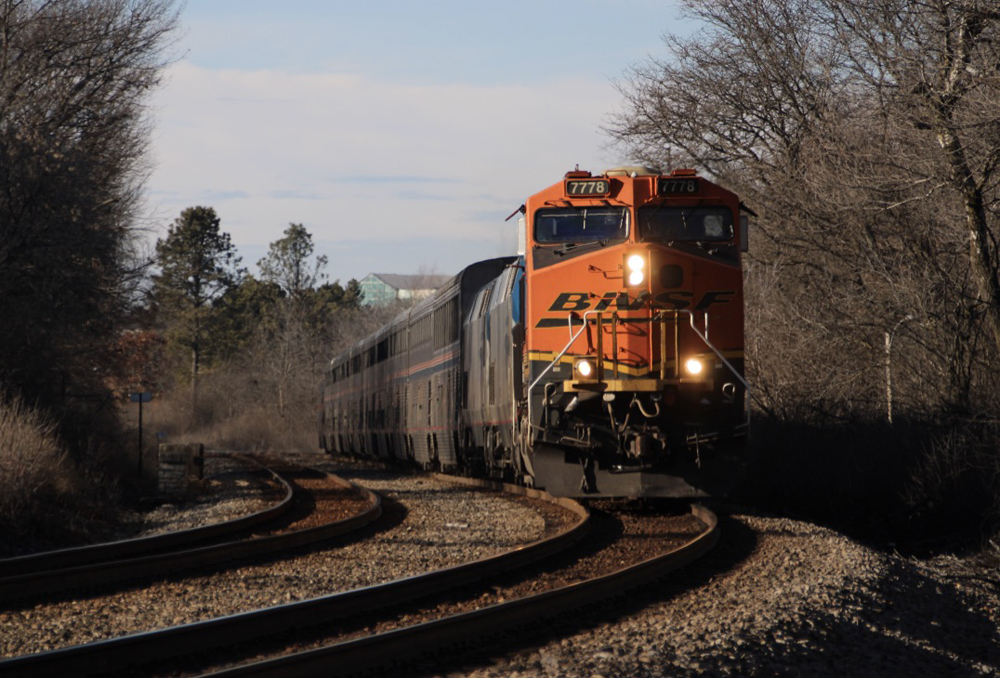 Passenger train with freight locomotive in lead