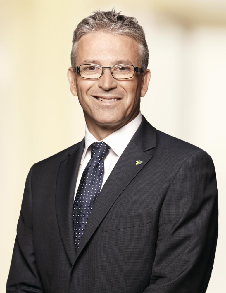 Head-and-shoulders portrait of man with glasses in suit