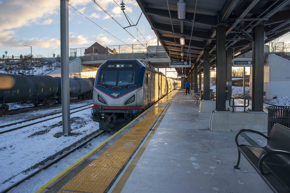 Electric locomotive leads train into station