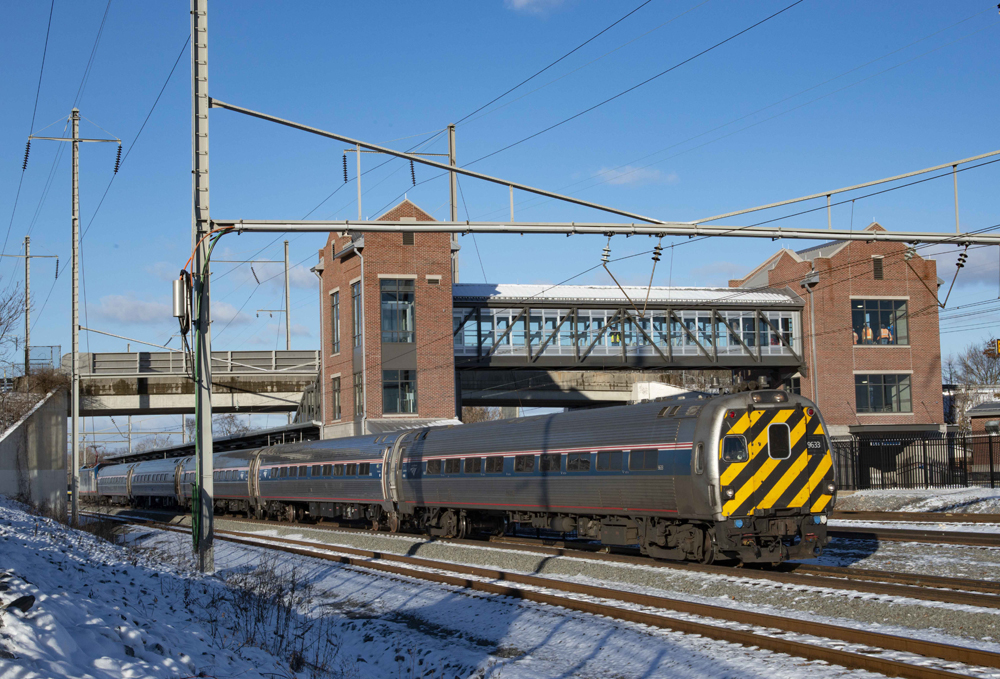 Passenger train led by cab car at new station