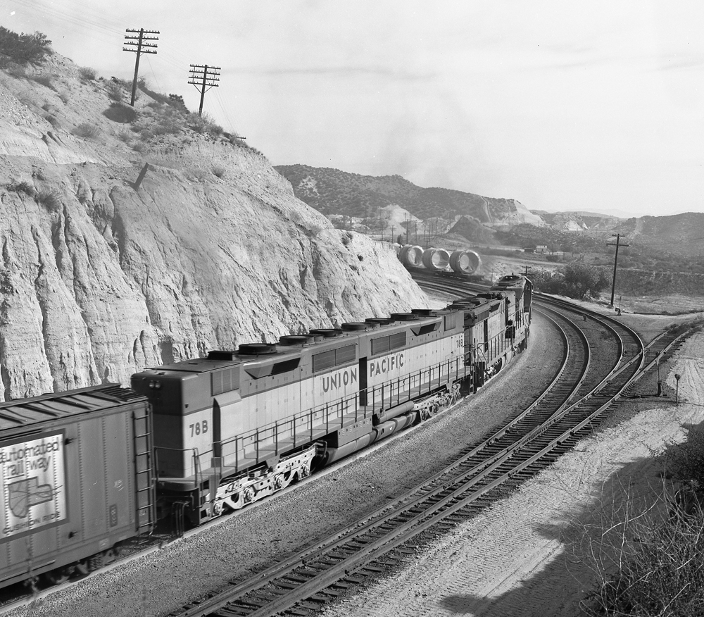 Black and white photo of booster unit with two four-axle trucks.