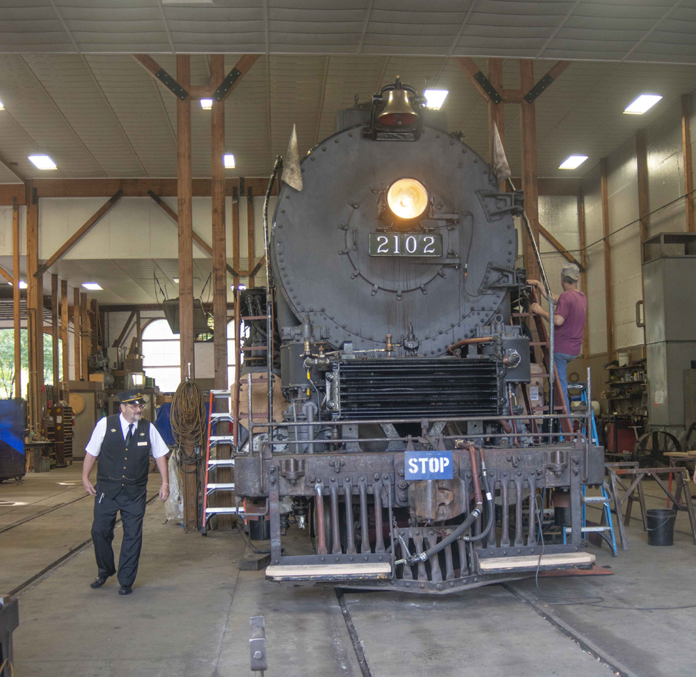 Front view of steam engine in shop building