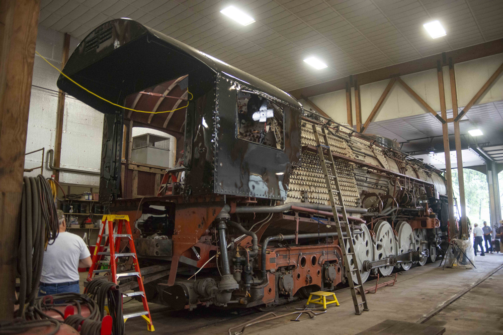 View from cab end of steam locomotive under repair