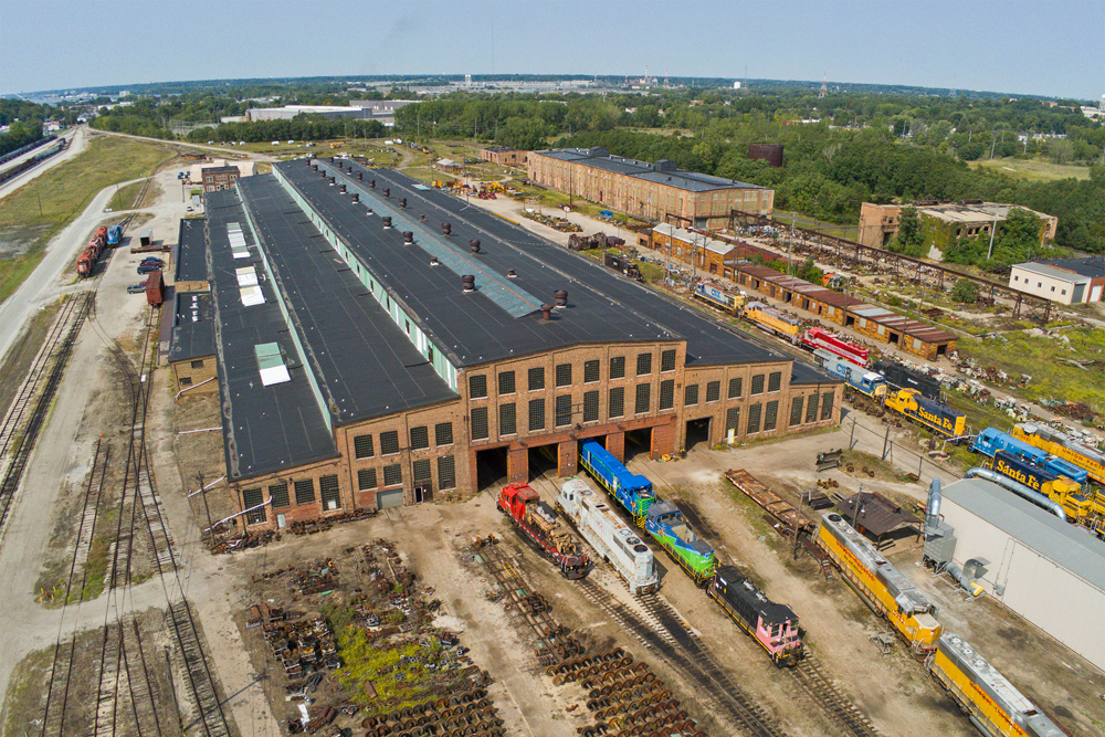Aerial view of large brick building in railroad shop complex