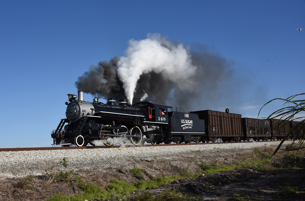 Steam locomotive pulling sugar cane cars