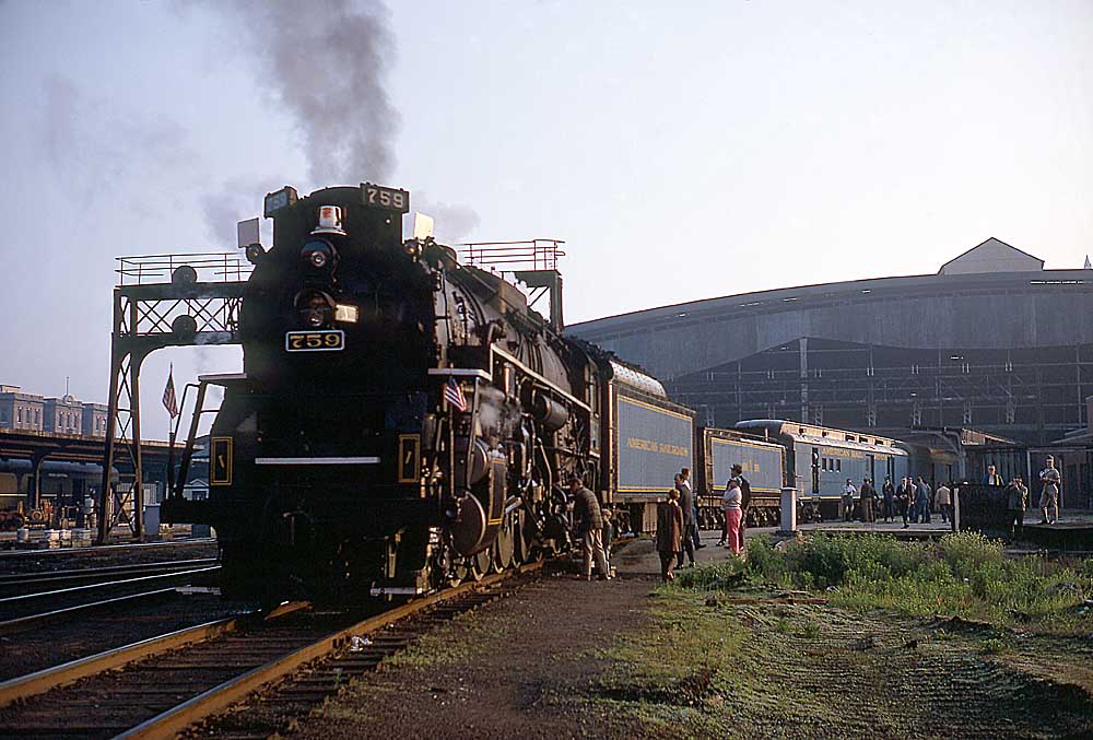 Passenger train with steam locomotive under station trainshed