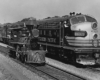 Southern Pacific locomotives: Small steam locomotive rests adjacent to larger streamlined diesel