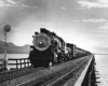 Southern Pacific freight trains: Steam locomotive leads freight train on bridge 