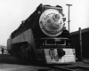 Nose of streamlined steam locomotive in yard