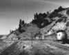 Streamlined diesel locomotives on freight train winding through curves on mountainside
