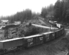 Train navigates curve and crosses road away from camera