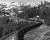 Tank car train snakes through snow-covered mountains