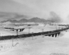 Southern Pacific freight trains: Steam locomotive with refrigerated cars on broad sweeping curve