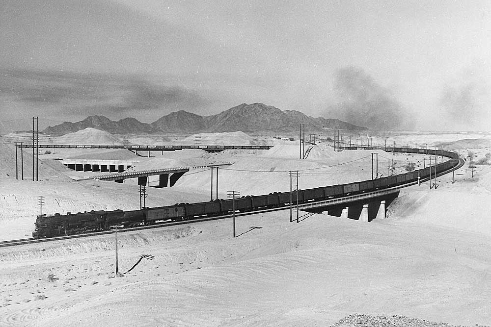 Southern Pacific freight trains: Steam locomotive with refrigerated cars on broad sweeping curve