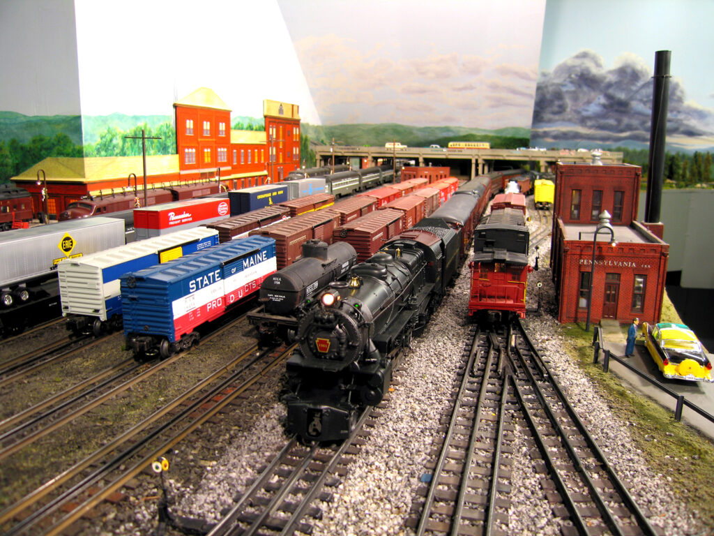 O gauge railroad yard with trains.