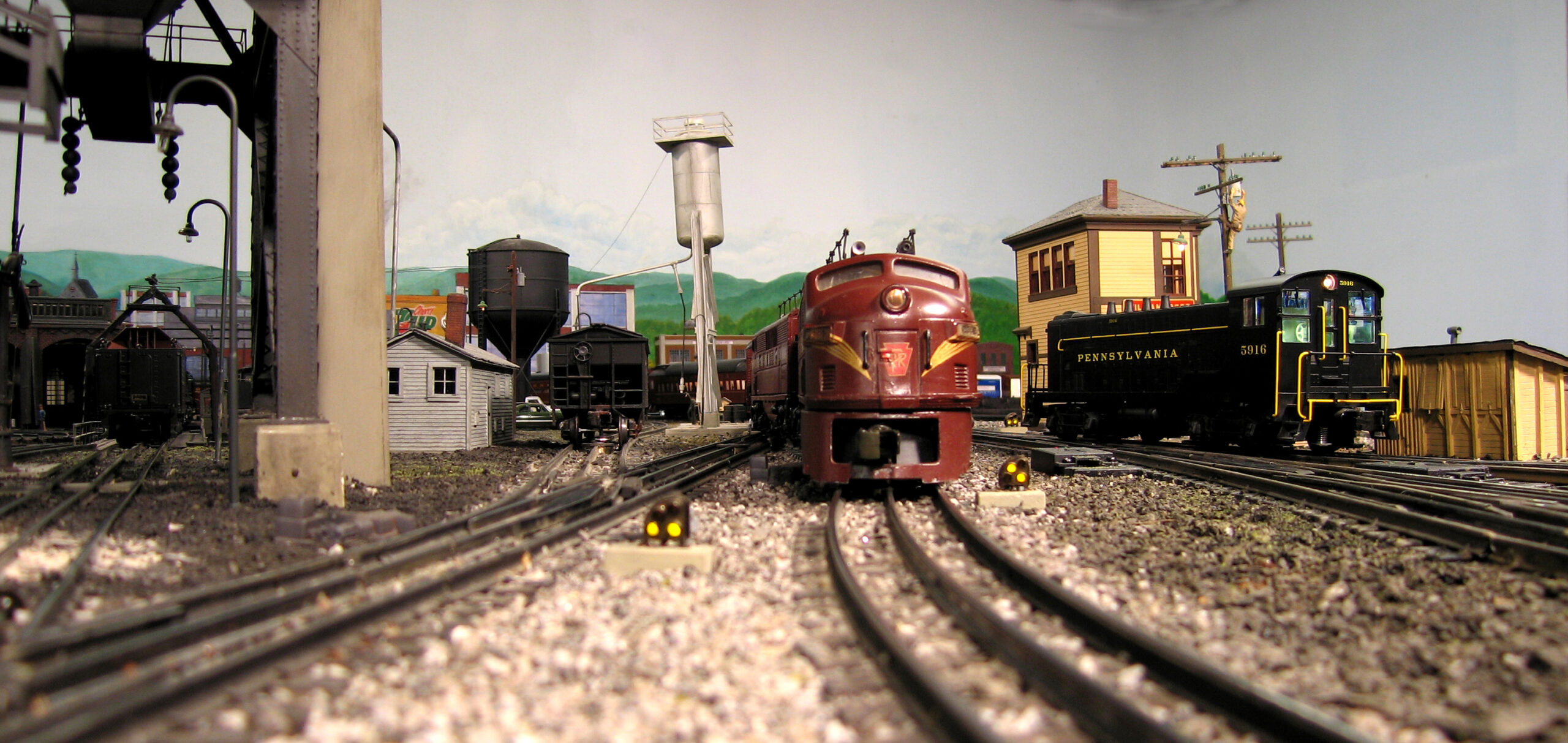 Locomotives near fueling facility and switch tower.