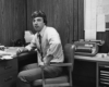 Black-and-white photo of man at a desk