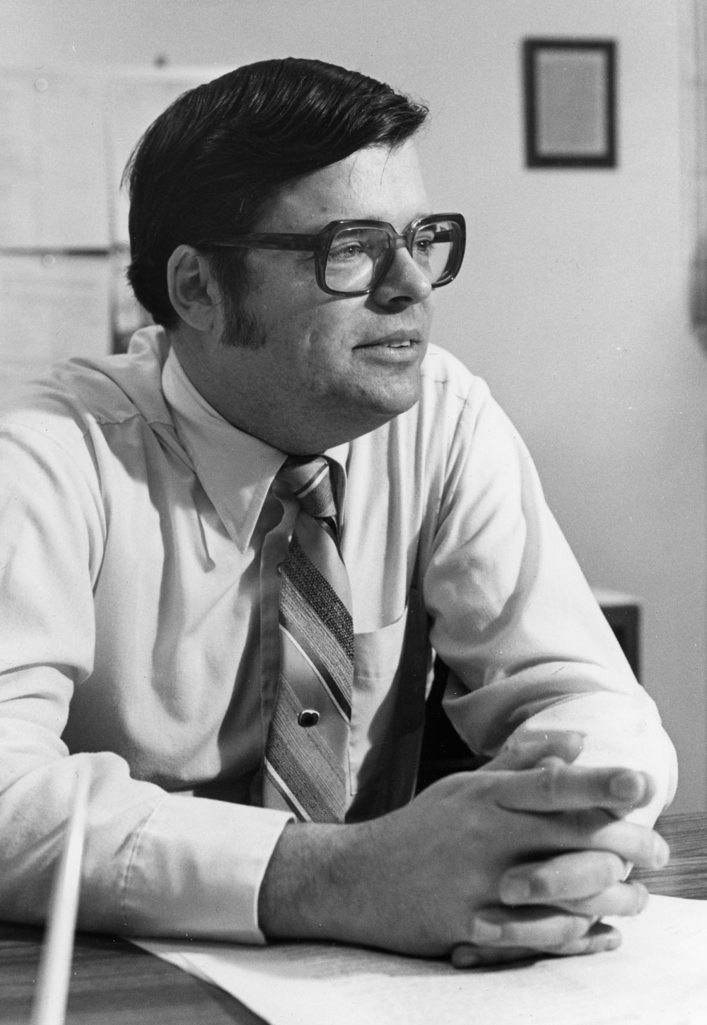 Black-and-white photo of a man with glasses