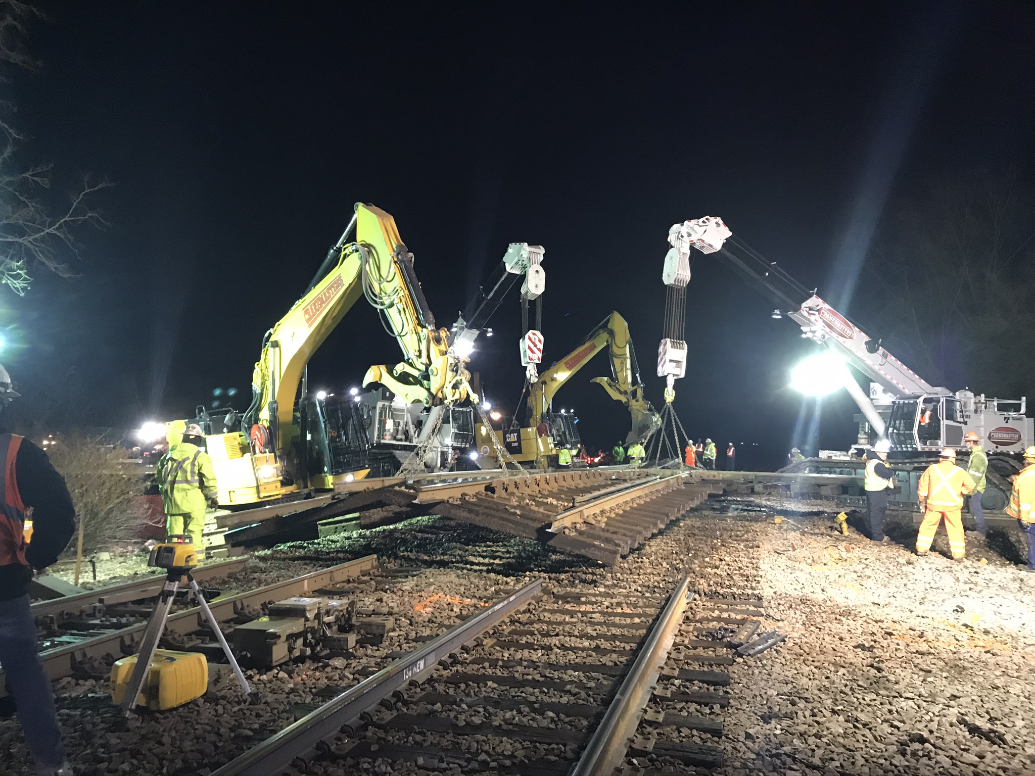 Four cranes lift the old diamond from the roadbed.