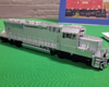 Silver painted preproduction sample locomotive on green tablecloth.