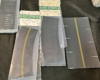 Sections of curved roadway in plastic packaging, straight roadway in stacks.