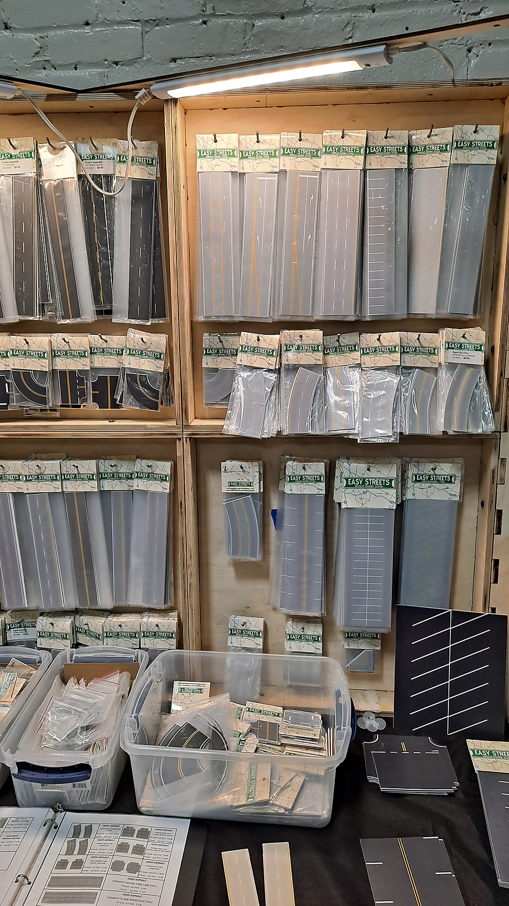 :] Display racks with packages of gray highway and parking lot sheets.