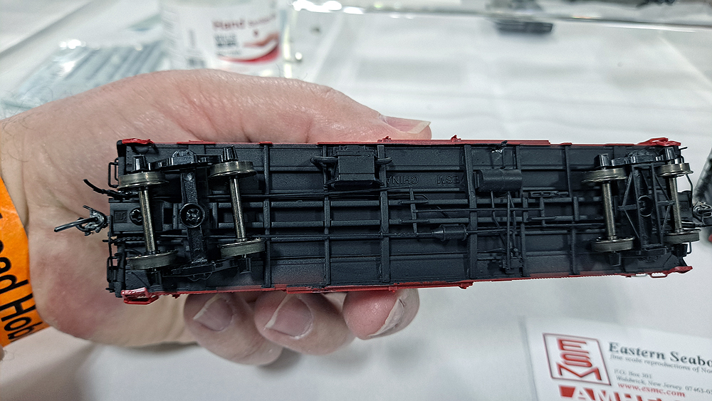 Bottom of boxcar painted black showing brake detail and charcoal heater.