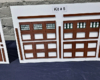 Structure walls and doors are mounted to a white board, with the assembled parts laying in front of the board on a table.
