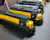 Yellow and green Chicago & North Western GP30s lead the row of locomotives.