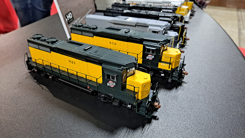 Yellow and green Chicago & North Western GP30s lead the row of locomotives.