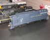Dark blue locomotive with high short hood, yellow Norfolk and Western lettering.