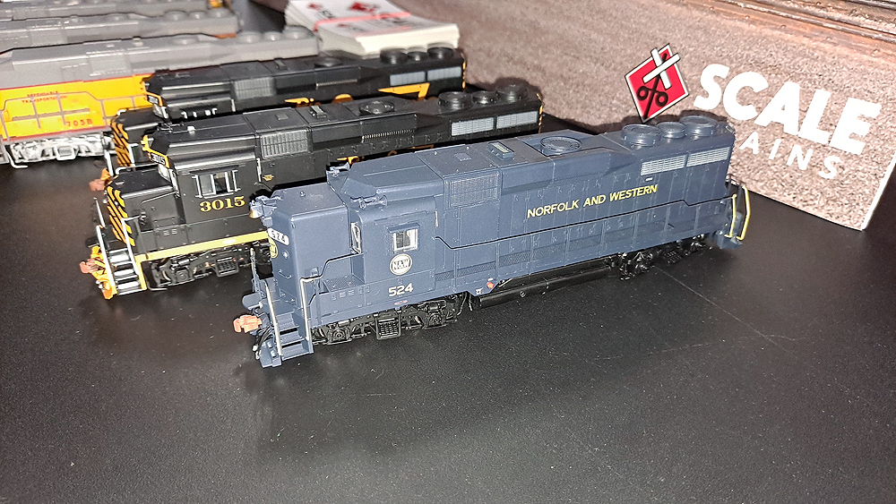 Dark blue locomotive with high short hood, yellow Norfolk and Western lettering.