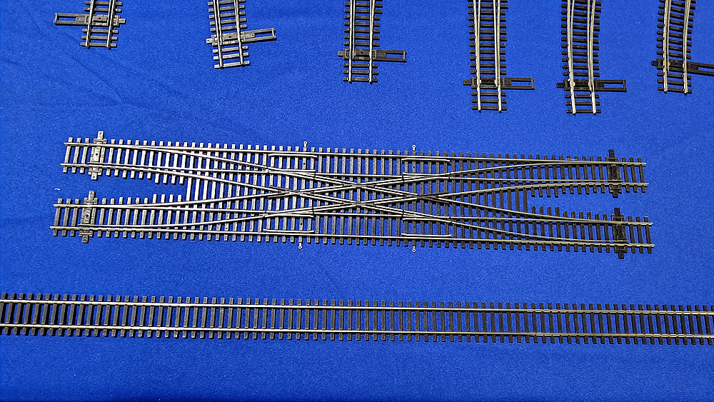 HO scale railroad track double crossover and section of flextrack.