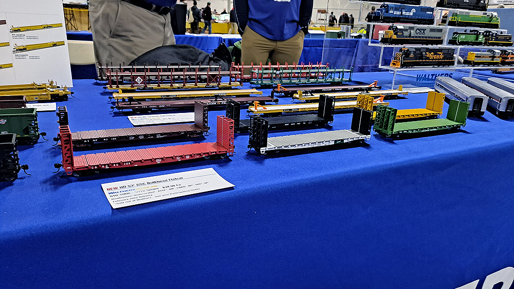 Six bulkhead flatcars stand in front of five TOFC flatcars and four bi-level auto racks.