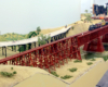 Don Ball model railroad images: Steam-era freight train crossing over bridge on scenicked model railroad.