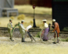 HO scale figures and 1890s-style bicycles on a model railroad.