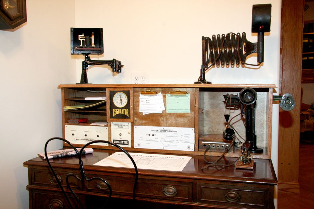 Photo of desk and chair with late 1880s railroad communication equipment.