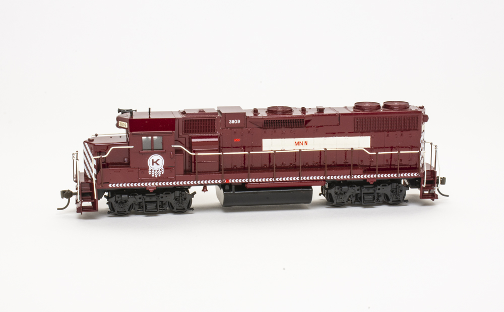 Photo of HO scale EMD hood unit painted maroon with white graphics on a white background.