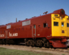 boxy dark red locomotive with flat yellow nose