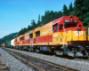 red and yellow locomotives leading mixed train of boxcars